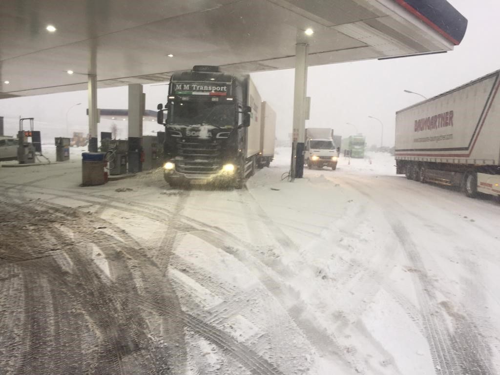 Truck refuelling at a snowy petrol station