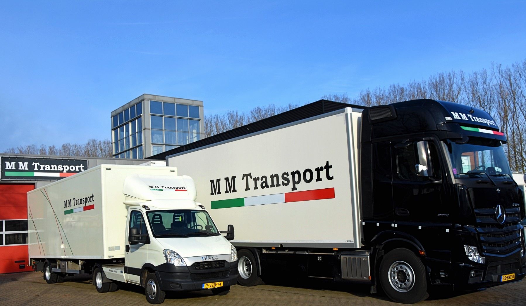 M M Transport box truck and black Mercedes tractor at the depot